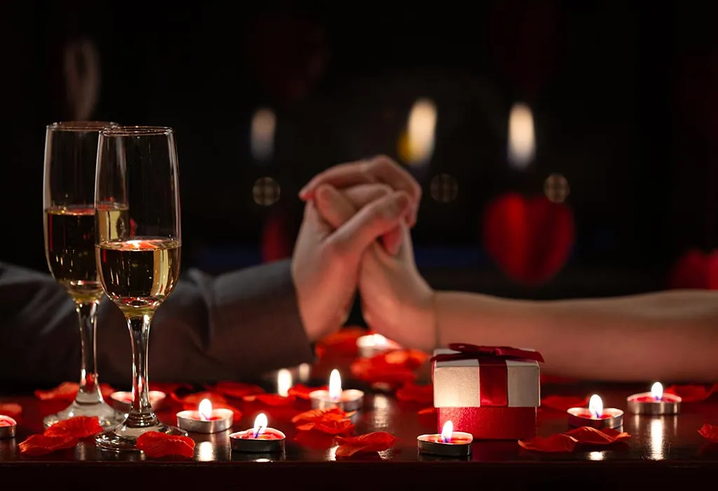 Candlelit date night in Austin with champagne, rose petals, and held hands.