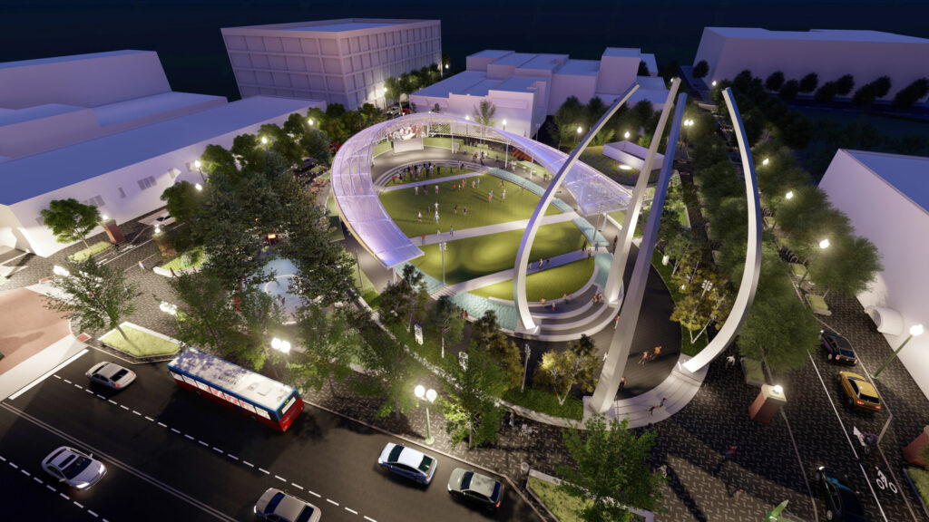 Night aerial rendering of a modern urban park with curved architecture, illuminated canopy, green lawn, and surrounding city traffic
