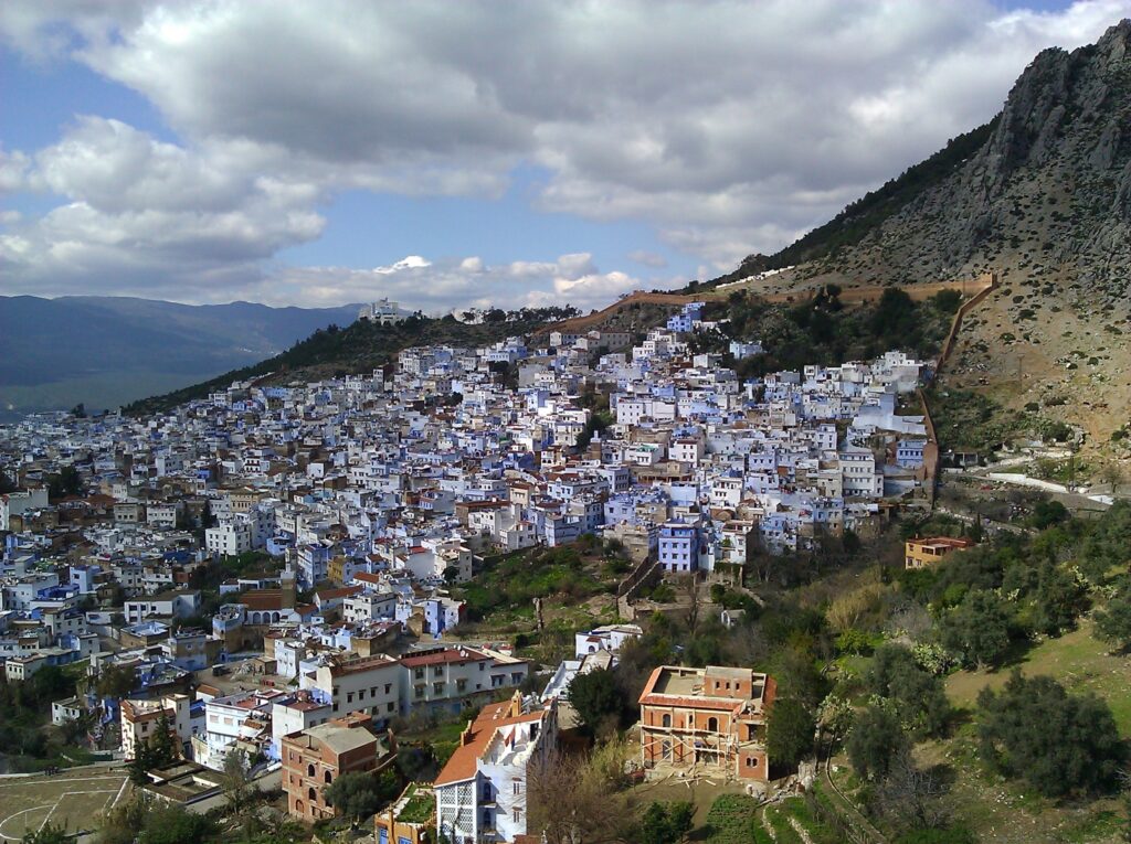 Panoramic view of Chefchaouen, Morocco with blue-painted buildings nestled in the Rif Mountains – Travel Crock