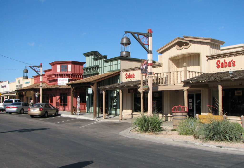 Colorful Western-style storefronts and shops along a sunny street in Old Town Scottsdale, Arizona, featuring rustic architecture and vintage charm.