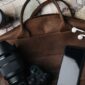top view of brown leather bag with photo camera l 2024 11 18 00 49 27 utc 85x85