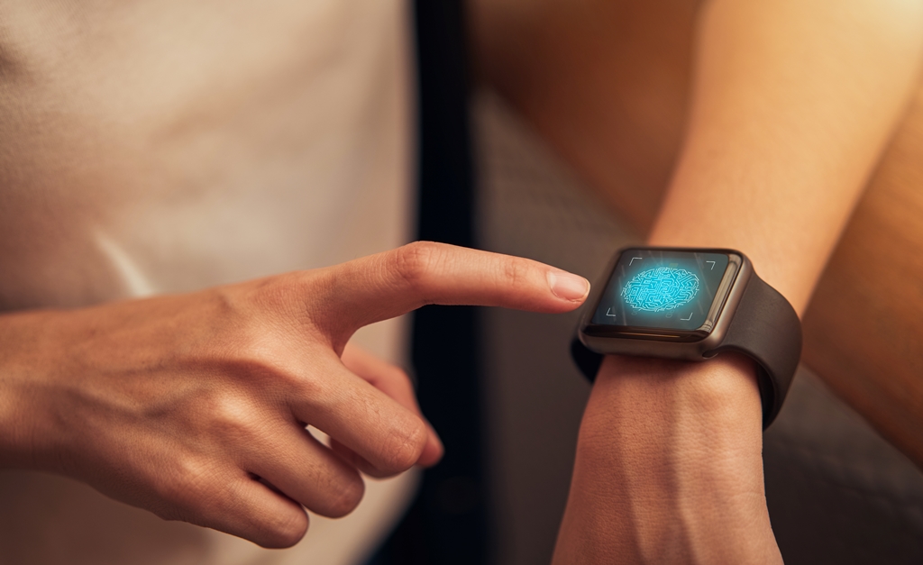 Close-up of a woman using fingerprint scan on a smartwatch—ideal wearable tech for secure, on-the-go travel with Travel Crock