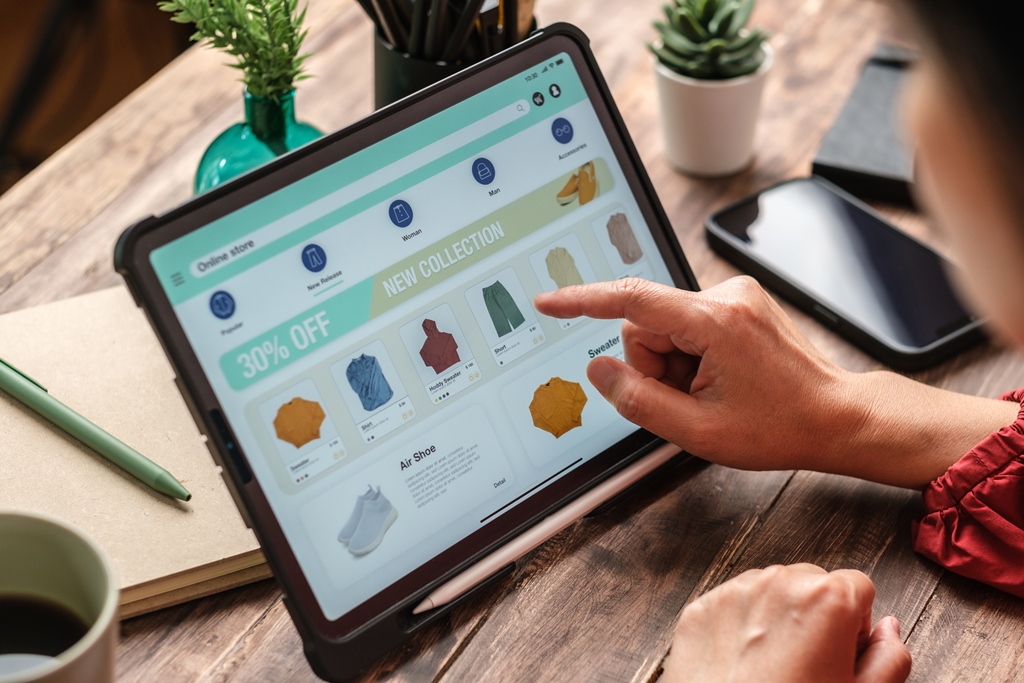 "Person browsing a digital storefront on a tablet while managing an online dropshipping business"